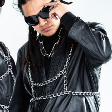 Person wearing black leather jacket with chain details and sunglasses. Metal Chain Harness
