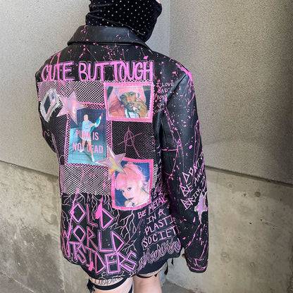 Person wearing a black jacket with pink text and graphics against a plain background