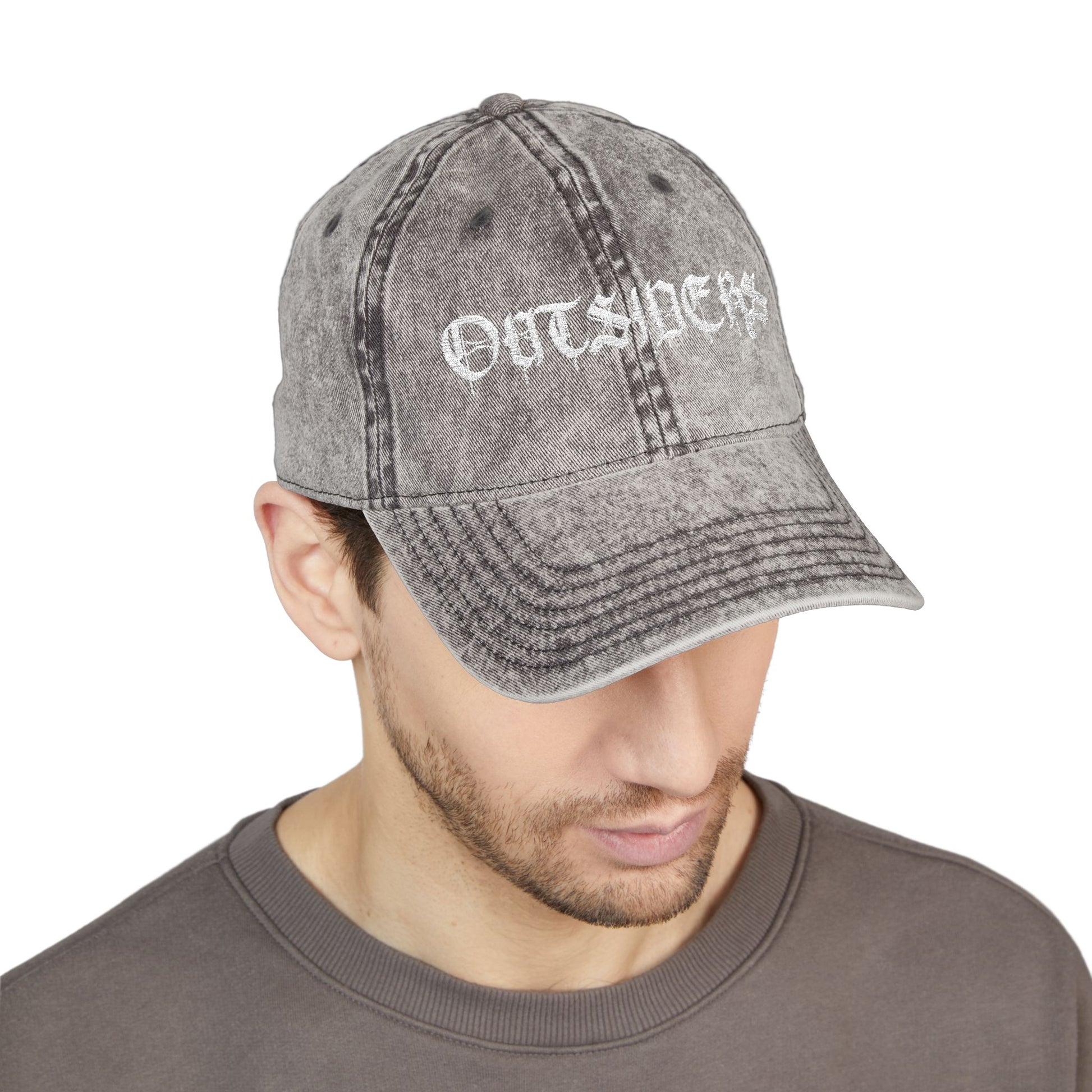 Man wearing a gray distressed cap with 'OUTSIDERS' text on a white background