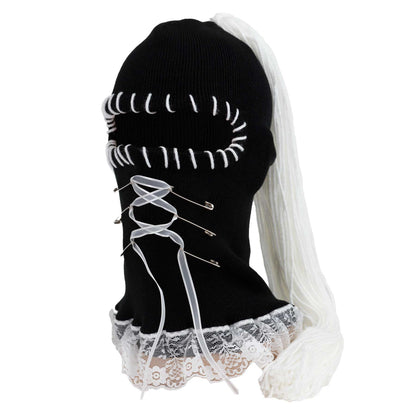 Black beanie with white lace and ribbons on a white background
