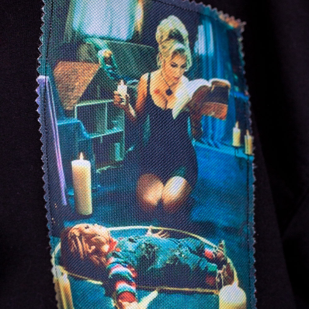 Fabric with a printed design of a woman at a fortune teller's desk with candles and a crystal ball.