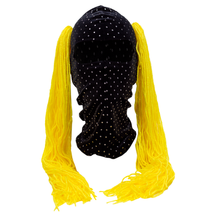 Black wig with yellow pigtails on a mannequin head against a white background