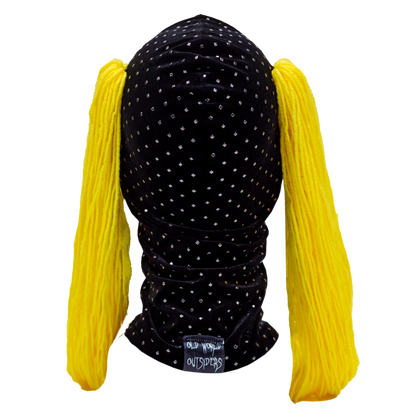 Black polka dot headband with yellow pigtails on a white background