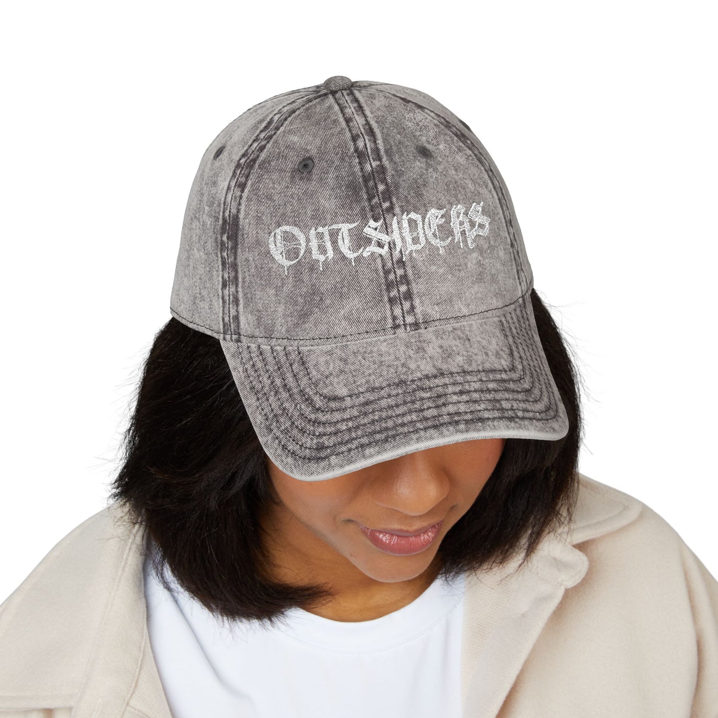 Person wearing a gray distressed baseball cap with 'OUTSIDERS' text on a white background