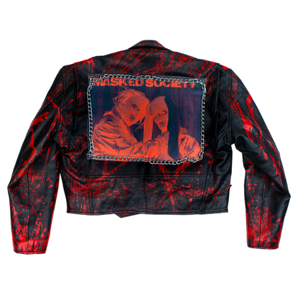 Black leather jacket with red splatter design and 'Masked Society' patch on a white background