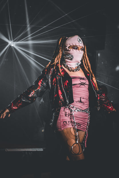 Person in a costume with a dark background and stage lights