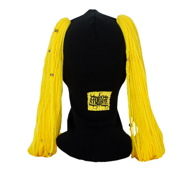 Black ski mask balaclava with yellow hair extensions and a visible brand logo on a white background