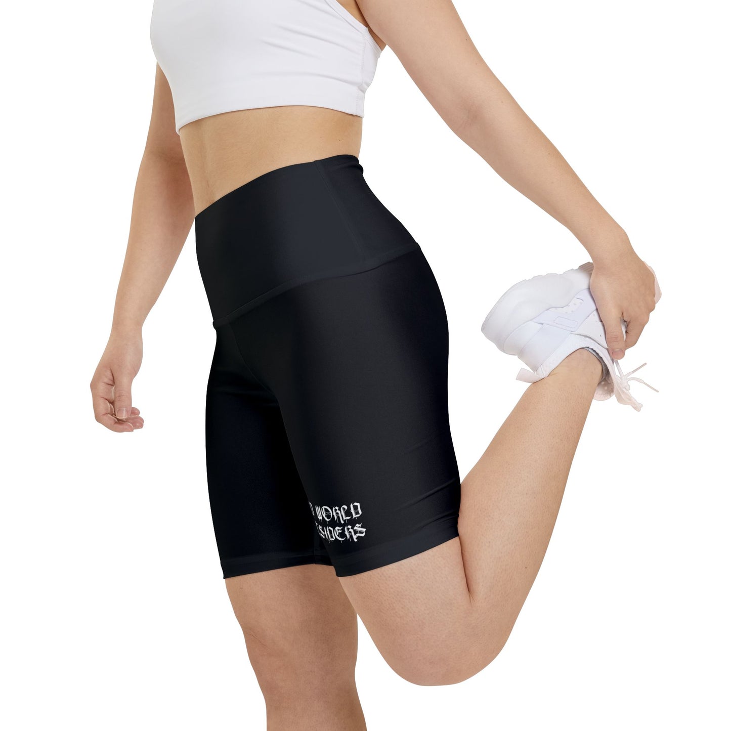 Person wearing black athletic shorts with a brand logo on a white background