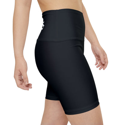 Black athletic shorts worn by a person on a white background