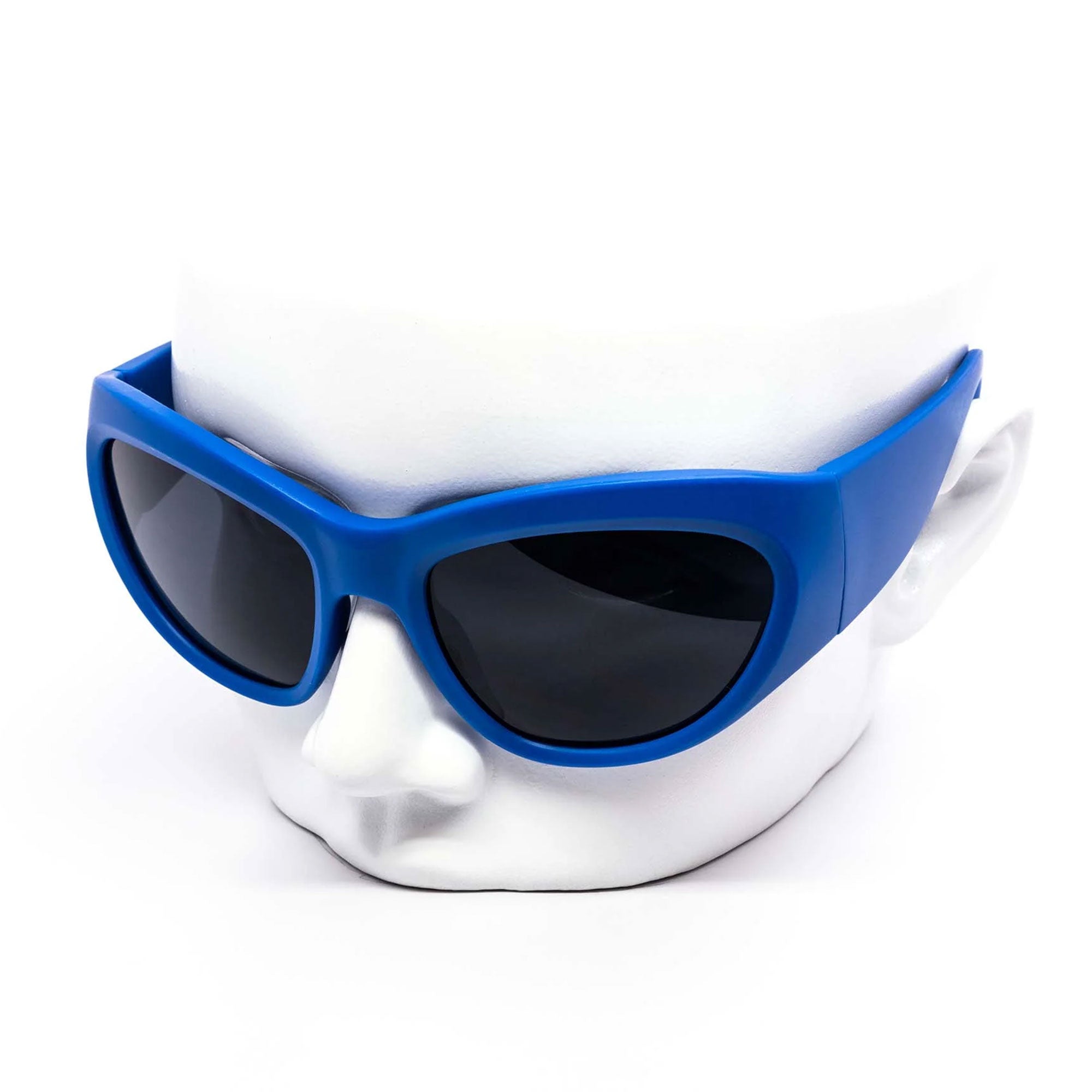 Blue sunglasses on a white mask against a white background