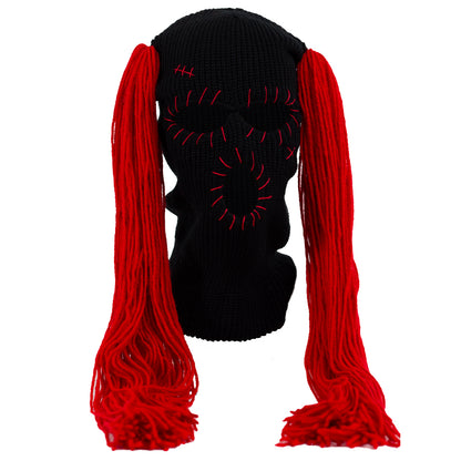 Black ski mask with red hair extensions on a white background