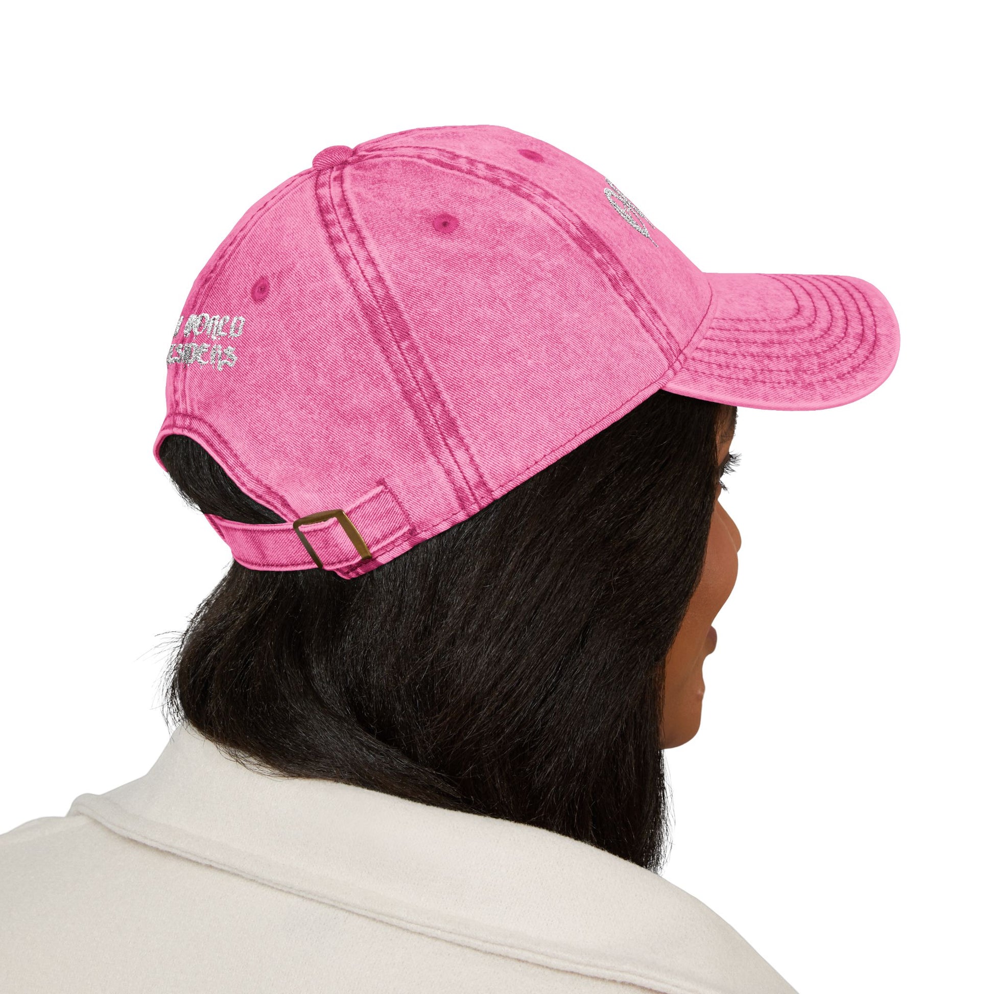 Person wearing a pink cap with a logo on a white background