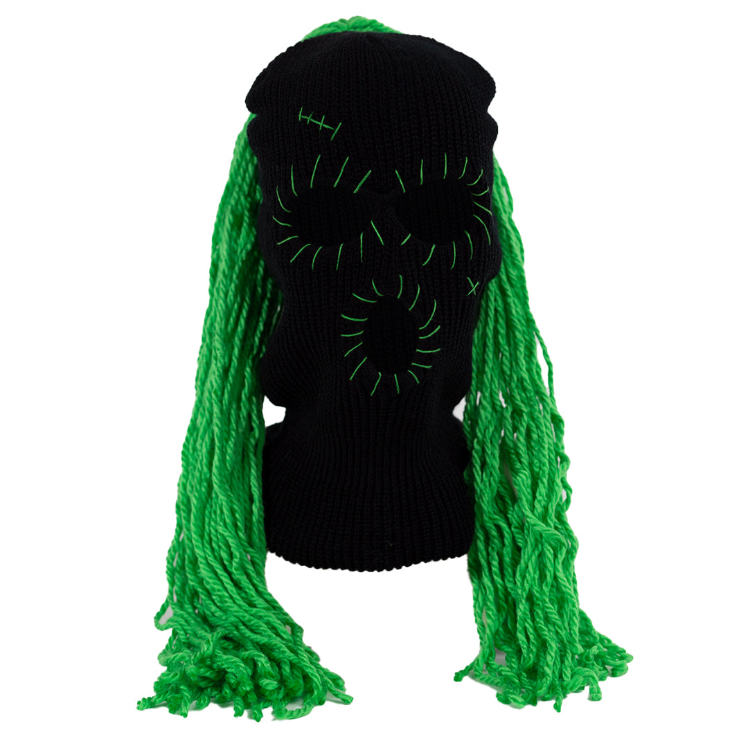 Black ski mask balaclava with green hair extensions on a white background