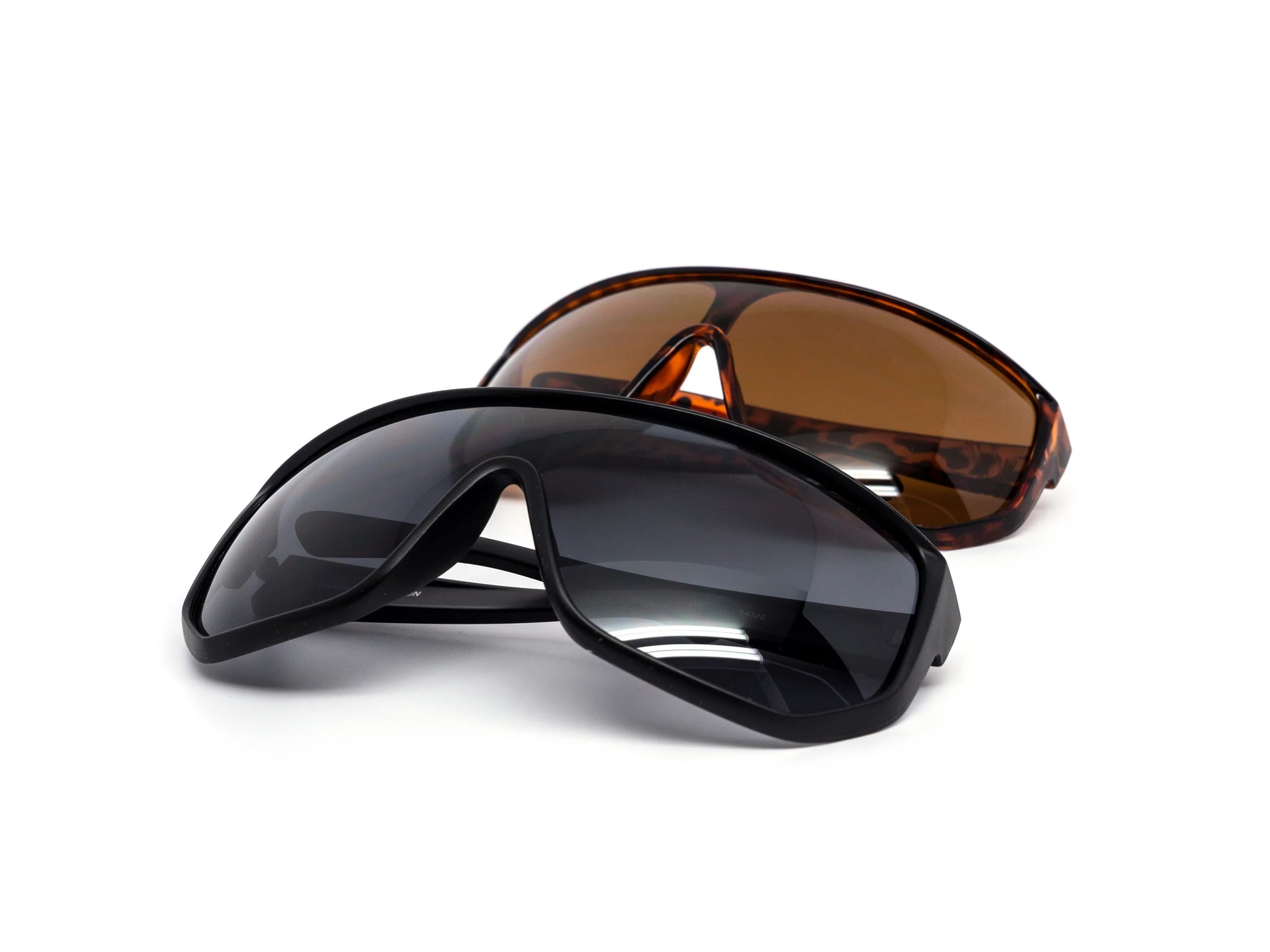 Two pairs of sunglasses, one black and one brown, on a white background