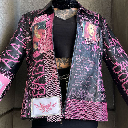 Black and pink jacket with graphic designs and text on a neutral background